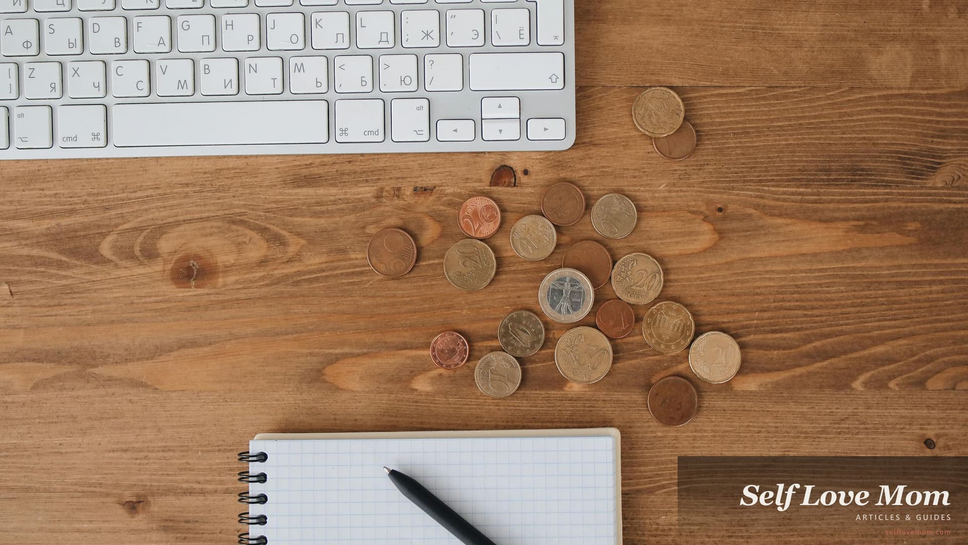 Calculator, coins, and a notebook on a desk, the basic stack of monthly money tracking that the budget apps below replace and improve.